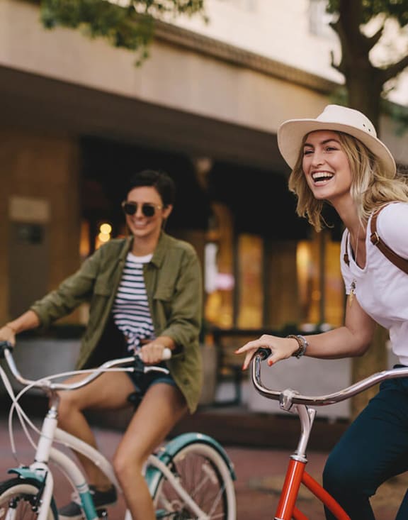 Stock Photo of Two Women Riding Bikes-MEDAM.
