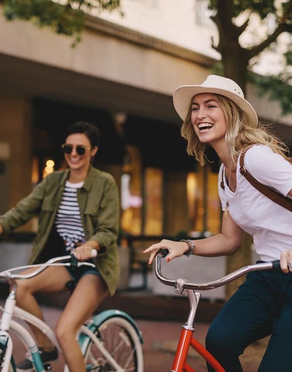 Stock Photo of Two Women Riding Bikes-MEDAM.