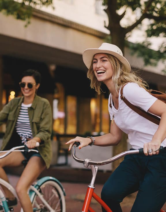 Stock Photo of Two Women Riding Bikes-MEDAM.
