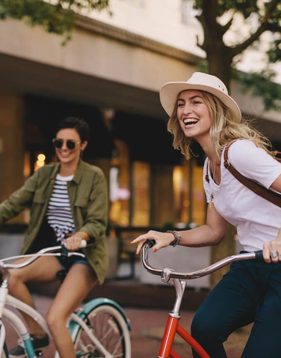Stock Photo of Two Women Riding Bikes-MEDAM.