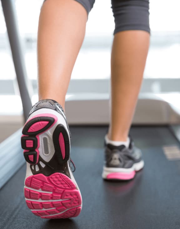 Woman running on a treadmill at the fitness center