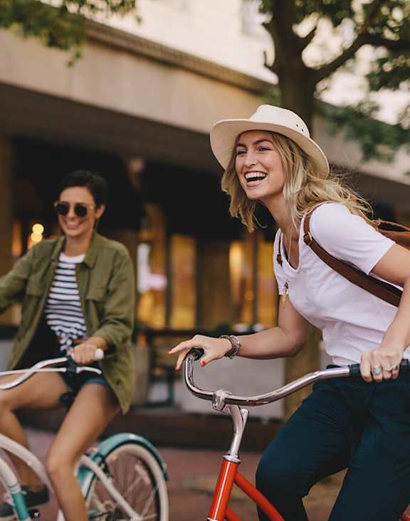 Stock Photo of Two Women Riding Bikes-MEDAM.