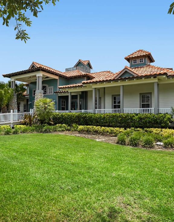 Resident clubhouse exterior and greenery at Veranda at Westchase Apartments in Tampa, Florida