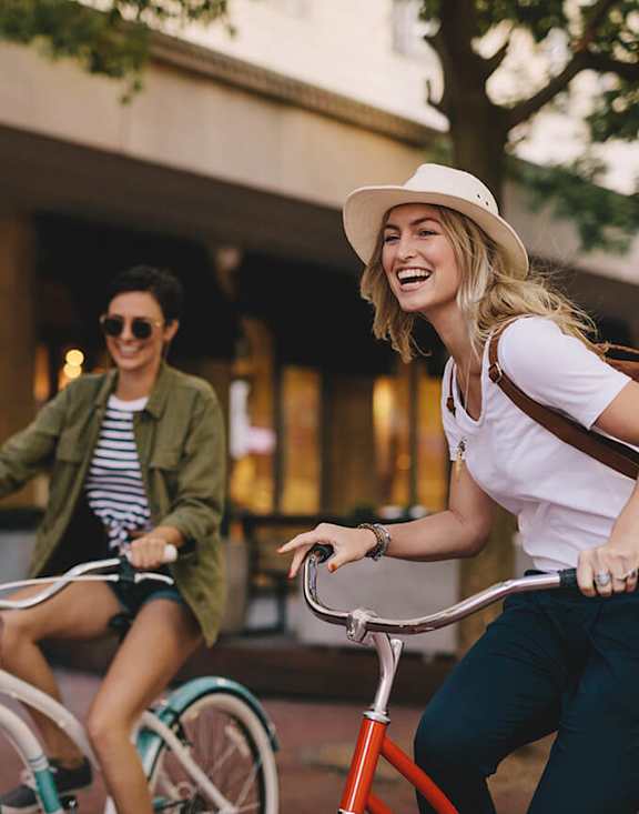 Stock Photo of Two Women Riding Bikes.
