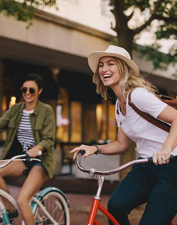 Stock Photo of Two Women Riding Bikes.