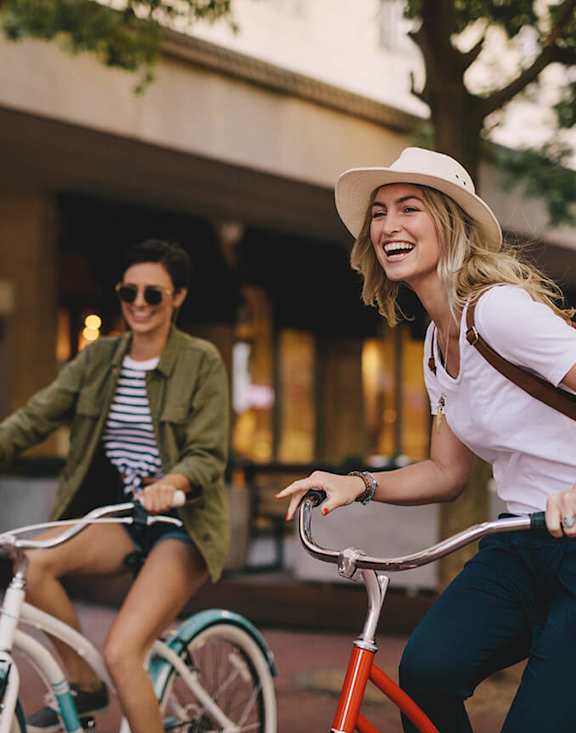 Stock Photo of Two Women Riding Bikes.