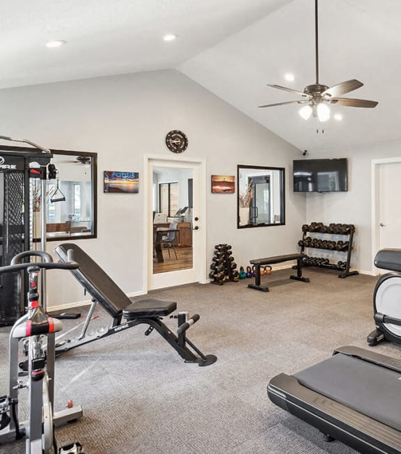 a gym filled with cardio equipment and weights at Bella Vista, St. George, UT, 84790