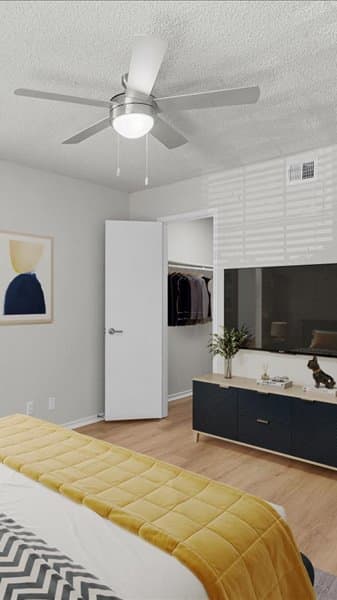 a bedroom with a bed and a window with red curtains  at Highland Park Apartment Homes, Kansas, 66214