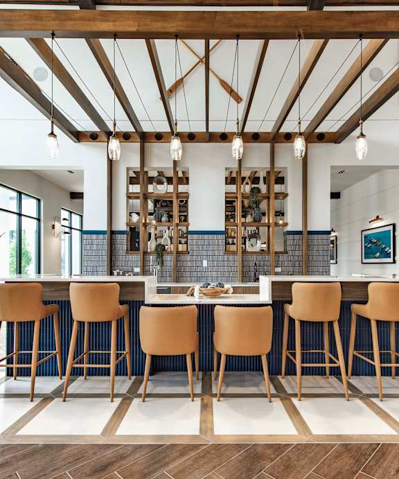 A modern dining room with a large table and chairs at Stillwater Lakes Apartments, Florida 34744