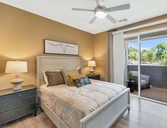 a bedroom with a large bed and a ceiling fan