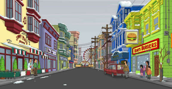 A street scene with a red car driving down the road.