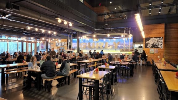 a group of people sitting at tables in a restaurant