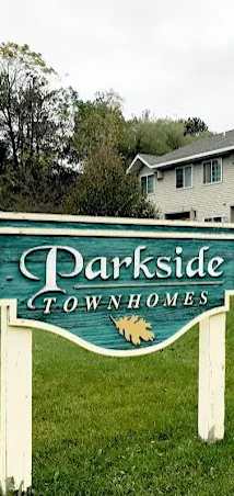 A sign that says "Darkside Townhomes" stands in front of a house.