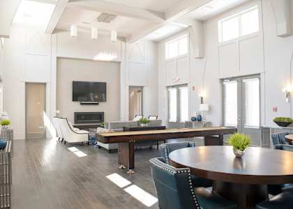 a living room with a table and chairs and a television at GrandView Flats and Townhomes, Granger