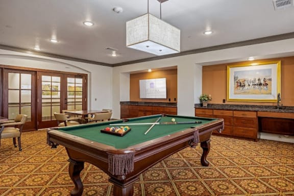 a game room with a pool table at Mariposa at Harris Road Arlington 55+ Apartments, Texas