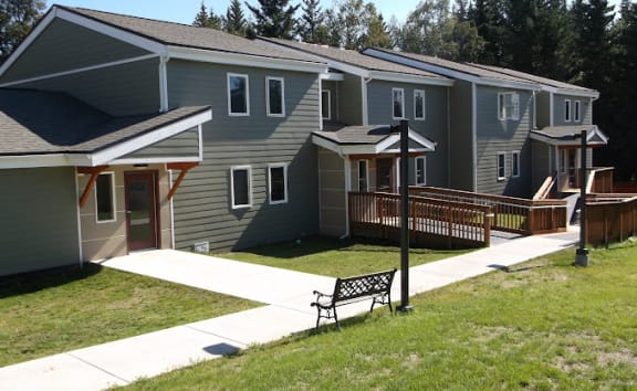 Father playing with kids in apartment at Conifer Woods Apartments, Homer