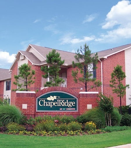 a building with a sign in front of it at Chapel Ridge of Stillwater I & II, Stillwater, Oklahoma