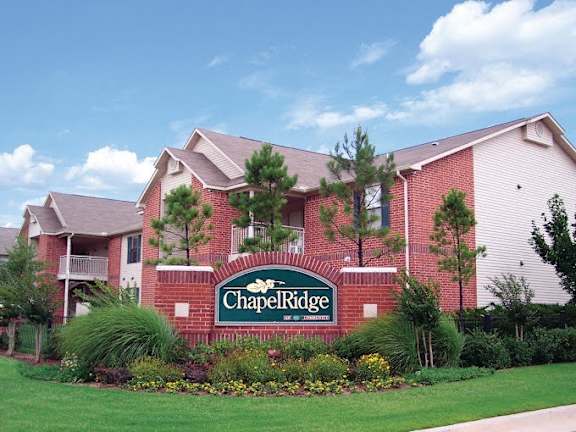 Apartment building with signage in front of it  at Chapel Ridge of Stillwater, Stillwater, OK, 74075