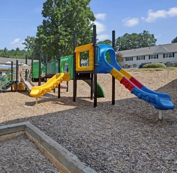a playground with two slides and a monkey bars