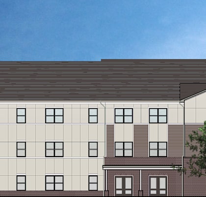 A modern building with a combination of brown and beige colors.