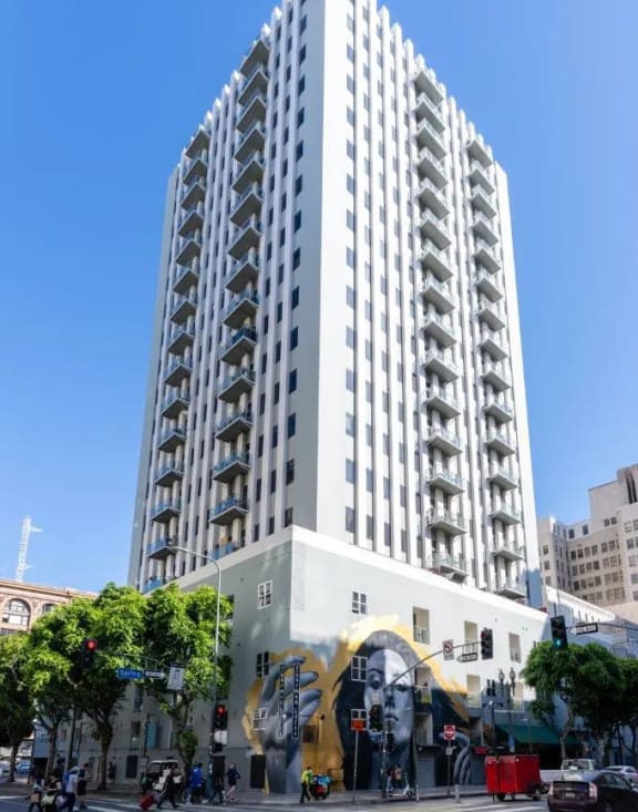 a tall building on a city street with a blue sky