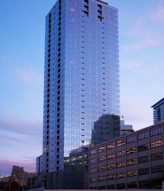 a tall glass building in the city