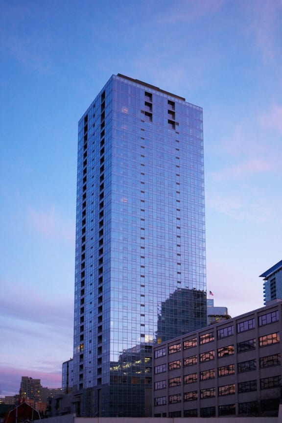 a tall glass building in the city