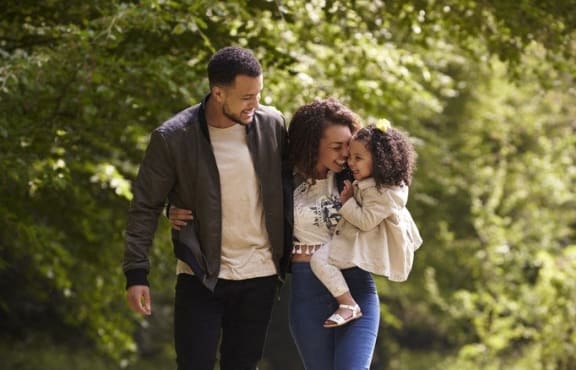 Family Smiling while Walking on Trail Together