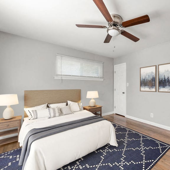 a bedroom with a bed and a ceiling fan