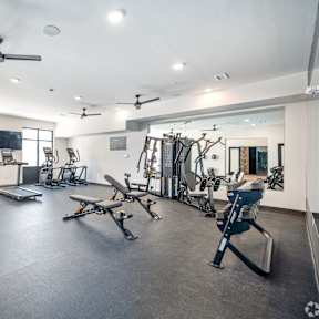 A spacious gym with a variety of equipment including treadmills, weights, and exercise machines.