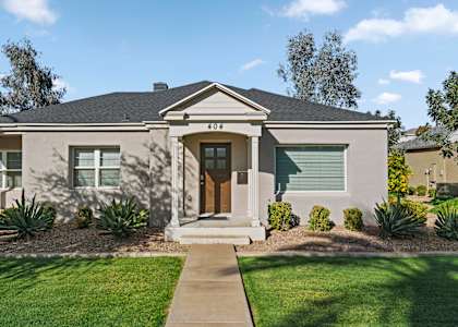 A house with a brown front door and a small porch.