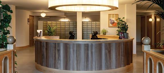 the lobby of a building with a reception desk and a door
