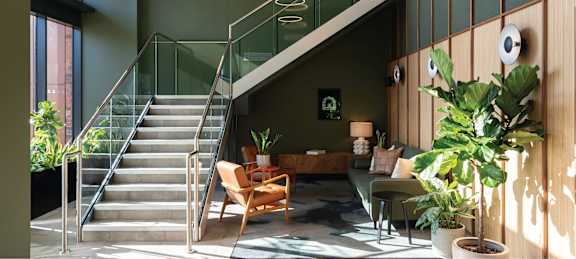 the lobby of a building with a reception desk and a door