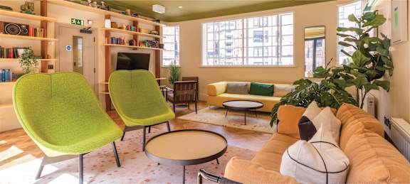 the lobby of a building with a reception desk and a door