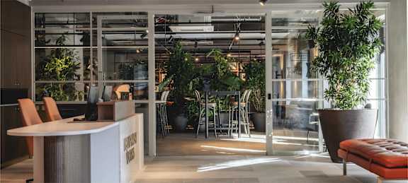 the lobby or reception area of a hotel with a reception desk