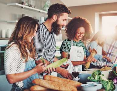 a group of people in a kitchen preparing food