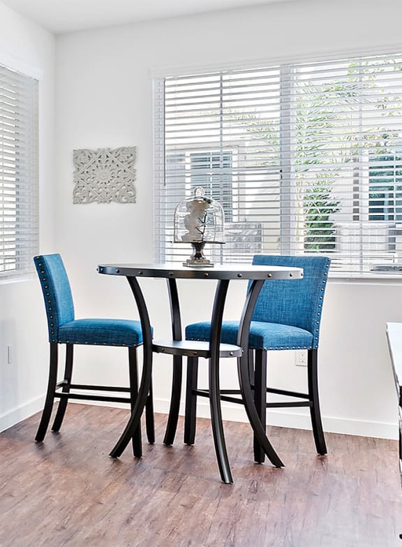 Table with chairs at Levante Apartment Homes in Fontana, CA