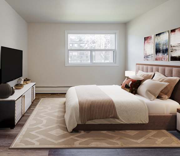 A bedroom with a large bed and a flat screen TV.
