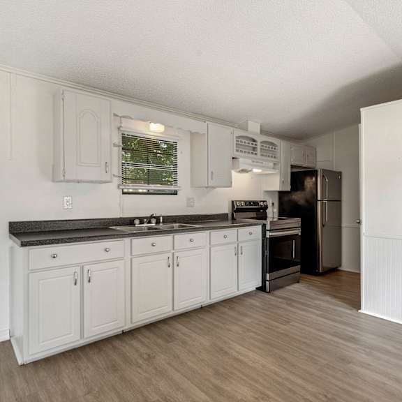 the preserve at ballantyne commons apartment kitchen with white cabinets and stainless steel appliances
