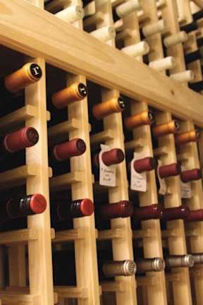 A wine rack with many bottles of wine.