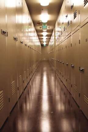 A long hallway with a series of lockers on the side.