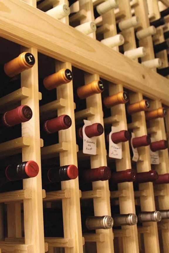 A wine rack with many bottles of wine.