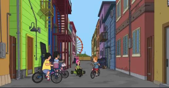 A group of people riding bikes down a street.
