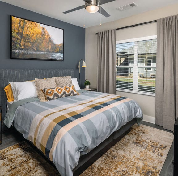 a bedroom with a bed and a ceiling fan at Fairview Springs in Covington, GA, 30016