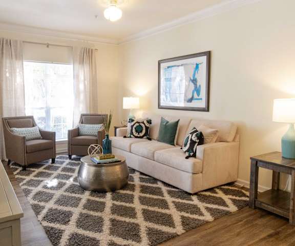 A living room with a couch, chairs, and a rug. at The Crest at Sugarloaf, Lawrenceville, GA, 30044