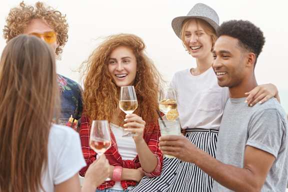 A group of friends enjoying a glass of wine at AVIA North Shore Apartments, Indiana, 47130