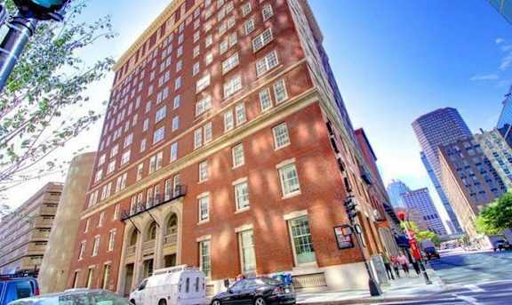 a tall brick building on the corner of a city street