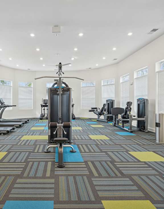 a gym with exercise bikes and a treadmill