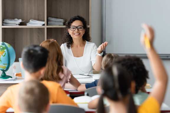 A teacher is teaching a class of students in a classroom.