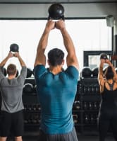 a group of people lifting weights in a gym